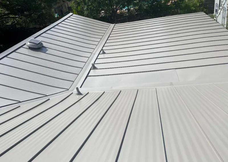 Solar attic fan installed on a metal roof for Roof Ventilation in Rockville