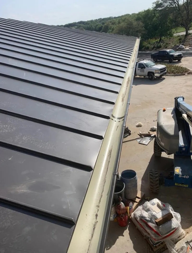 Standing seam panel and gutter detail on a metal roofing jobsite in Rockville